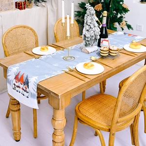 Christmas table runner featuring blue snowflake patterns and cute forest gnome prints