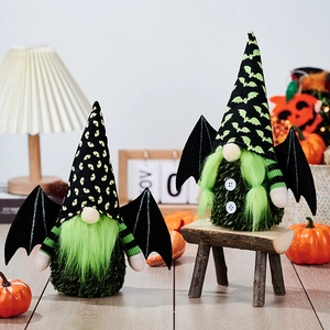 Pair of Halloween gnomes with green beards and bat wings on a cozy wooden holiday setting
