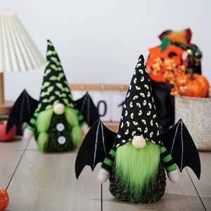 Halloween gnomes with green beard and black bat wings on a cozy festive tabletop