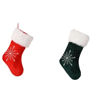 Set of large velvet Christmas stockings in red and green with white snowflake patterns