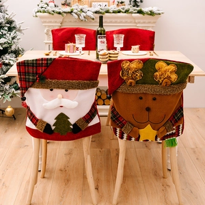 Christmas chair covers featuring plush 3D Santa and Reindeer designs in a festive dining room