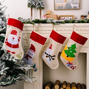 Set of four rustic burlap Christmas stockings featuring Santa, Snowman and Reindeer designs