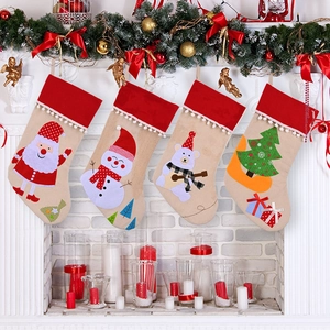 Linen Christmas stockings set with Santa and snowman hanging on a festive fireplace