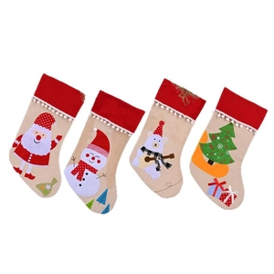 Set of four linen Christmas stockings with Santa, snowman and bear cartoon designs