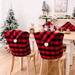 Red and black buffalo plaid Christmas chair covers with white pom-poms for dining decor