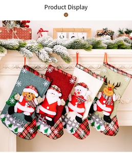 Macro view of Christmas stockings with plush Santa, Snowman, and Reindeer details