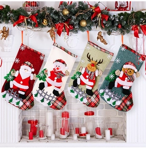 Detail of four burlap Christmas stockings with 3D Santa, Snowman, Deer and Bear on a fireplace