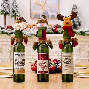 Three Christmas wine bottle covers featuring Santa, Snowman and Reindeer on a table