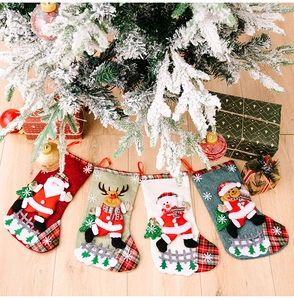Detail of four linen Christmas stockings with Santa, reindeer, snowman and bear characters
