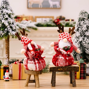 Christmas gnome dolls in reindeer antler hats inside red plaid gift bags for home decor