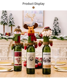 Three Christmas wine bottle covers featuring Santa, reindeer, and snowman in a cozy setting