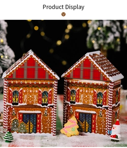 Macro view of house-shaped Christmas gingerbread man tin boxes with festive plaid patterns