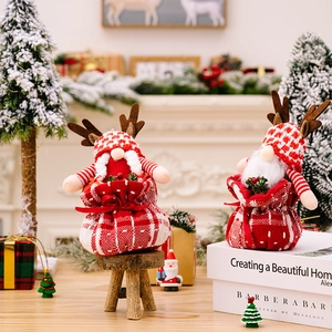 Christmas gnome plush set with reindeer antlers on a warm holiday background