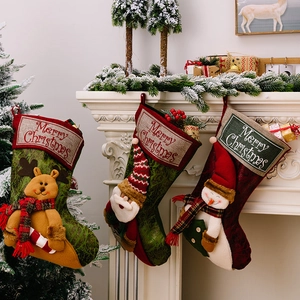 Christmas stocking set with 3D Santa, Reindeer and Snowman dolls on white fireplace