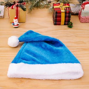 Premium blue plush Christmas hat with white trim on a festive wooden tabletop setup