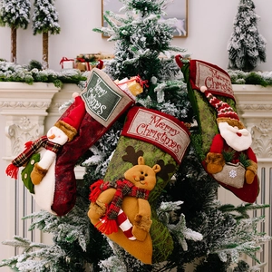 Christmas stocking set with 3D Santa, reindeer, and snowman hanging on a decorated tree