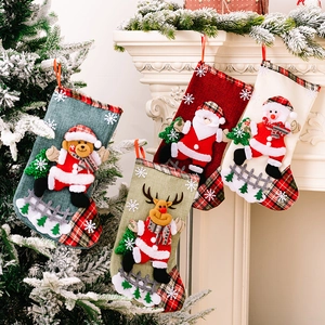 Set of four burlap Christmas stockings with cartoon characters hanging on white fireplace