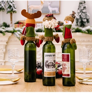 Detailed Christmas wine bottle covers featuring Santa, Reindeer and Snowman on a wooden table