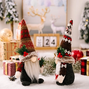 Christmas Gnomes pair with knitted hats, pine branches and berries for holiday decor