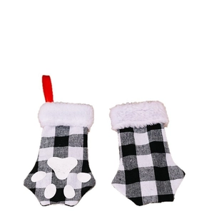 Christmas buffalo plaid pet stockings with white paw prints and plush faux fur trim