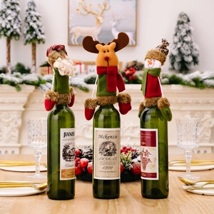 Three-piece Christmas wine bottle covers featuring Santa, reindeer, and snowman designs