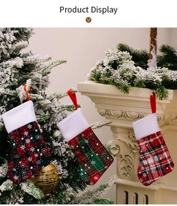 Close-up of festive plaid Christmas stocking cutlery holders with snowflake prints