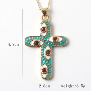 Detail view of the green enamel cross pendant with size markings 4.7cm by 2.8cm