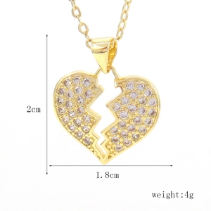 Detail view of a broken heart pendant with micro-paved zircons measuring 2cm by 1.8cm