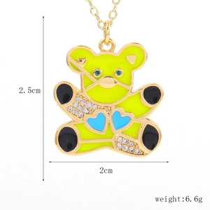 Detailed macro view of golden bear pendant with micro-set zircon and yellow oil drip design