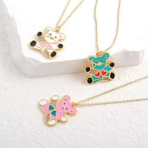 Detailed view of colorful enamel bear pendants with micro-pave cubic zirconia on gold chains