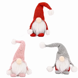 Three Christmas gnomes with knitted hats and long white fur beards on white background