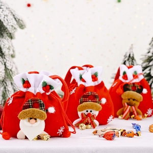 Detailed view of red velvet Christmas gift bags with 3D Santa and reindeer appliques