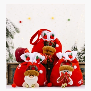 Close-up of red velvet Christmas gift bags with bells and snowflake patterns