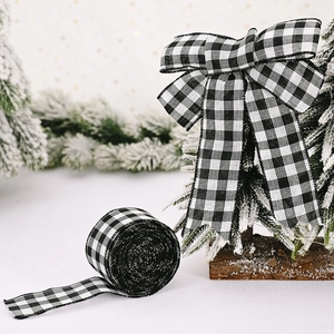 Classic black and white gingham Christmas ribbon roll with festive bow and snowy tree decor