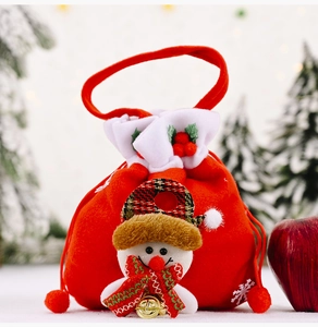Detail of red velvet Christmas drawstring gift bag with 3D snowman and golden bell
