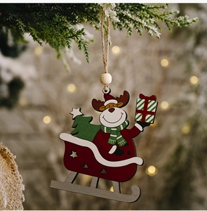 Detail of wooden Reindeer on sled ornament with Christmas tree and hanging jute rope