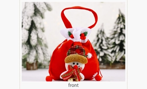 Detail of red Christmas velvet gift bag with snowman mascot and festive bells