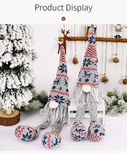 Detail of knitted Christmas gnomes with long legs and Nordic reindeer patterns