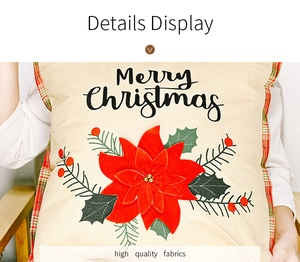 Detailed close-up of Christmas poinsettia pillow cover with Merry Christmas embroidery
