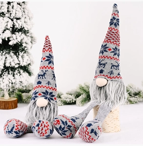 Detail of grey knitted Christmas gnomes with long legs and Nordic pattern hats