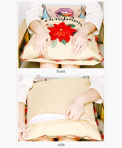 Close-up of Christmas pillow cover with red poinsettia and invisible zipper detail