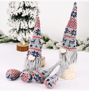 Detail of two Christmas gnomes with knitted Nordic patterns and long grey beards