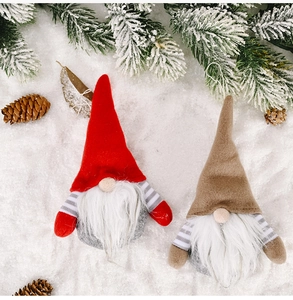 Detailed view of two Nordic Christmas gnomes with striped arms on snowy festive background