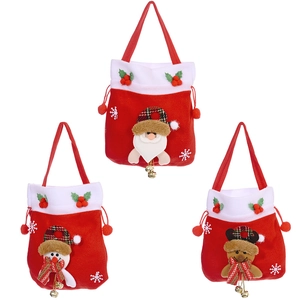 Three Christmas velvet gift bags featuring Santa, snowman, and reindeer with gold bells