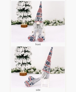 Front and side view of a gray knitted Christmas gnome plush with snowflake patterns
