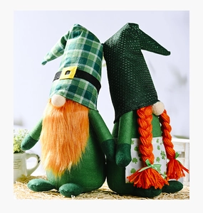 Close-up of Saint Patrick's Day plush gnomes with green hats and orange beards on a mat