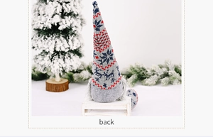 Rear view of a knitted Christmas gnome figurine with grey reindeer and snowflake patterns