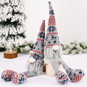 Set of two knitted grey Christmas gnomes with festive patterns on snow wood base