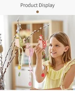 Detail of Easter wooden hen ornaments with plaid ribbons and beads hanging on a branch