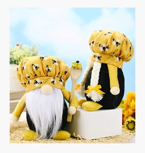 Close-up of handmade bee gnomes with chef hats and wooden spoon in a kitchen scene